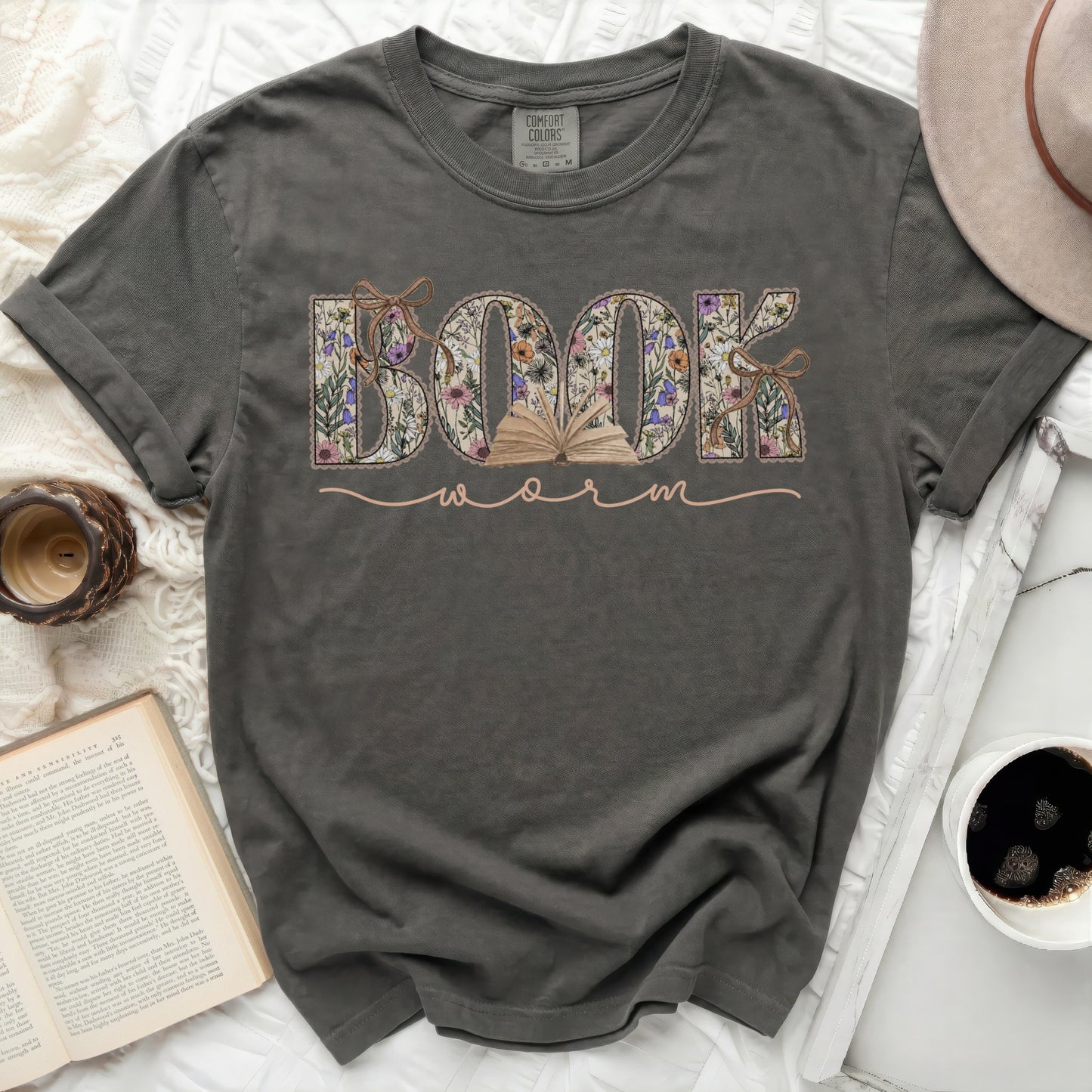 Dark gray t-shirt with "BOOK WORM" in floral block letters and open book design.