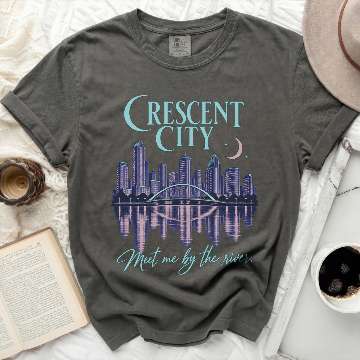 Grey t-shirt with "Crescent City" skyline graphic and "Meet me by the river." text.