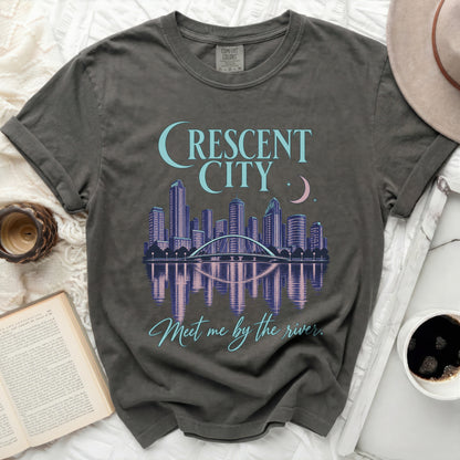 Grey t-shirt with "Crescent City" skyline graphic and "Meet me by the river." text.
