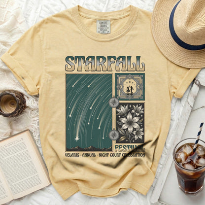 Yellow t-shirt with Starfall and festival design, featuring constellations and flowers.
