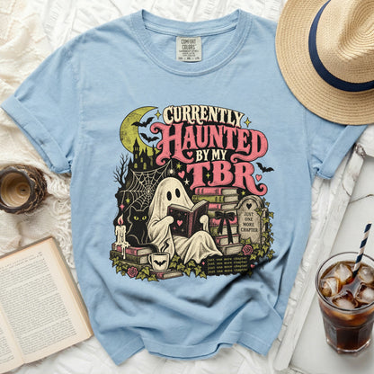 Light blue t-shirt with ghost, cat, and "Currently Haunted by my TBR" graphic.