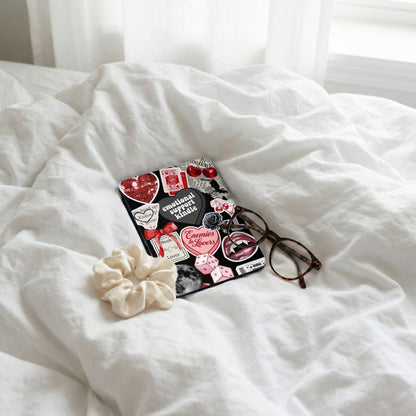 Kindle e-reader with various stickers like hearts, dice, and text.