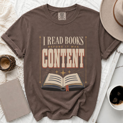 Brown t-shirt with "I read books before it was content" text and open book graphic.