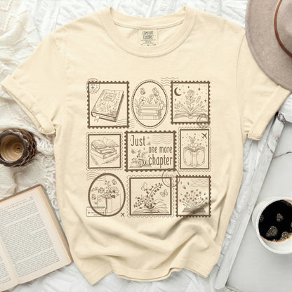 Cream t-shirt with stamp designs featuring books, flowers, and butterflies.