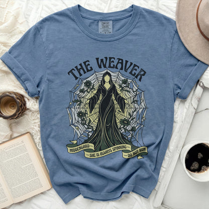 Blue t-shirt with "The Weaver" and spiderweb graphic; "Middengard She is Always Spinning Do Not Run".