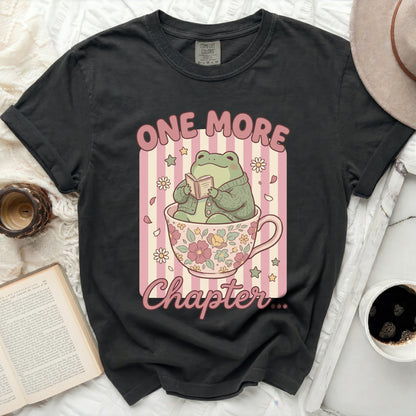 Frog in a teacup reading a book with text "One More Chapter".