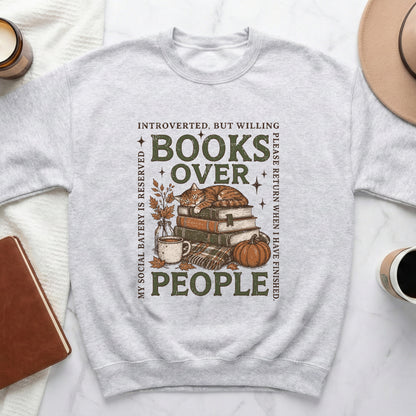 \"Introverted, but willing books over people\" graphic on a light grey sweatshirt.