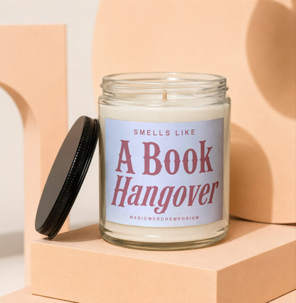 Glass candle with label that reads: Smells Like A Book Hangover. MagicMerchEmporium.