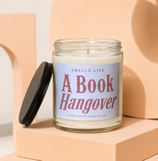 Glass candle with label that reads: Smells Like A Book Hangover. MagicMerchEmporium.