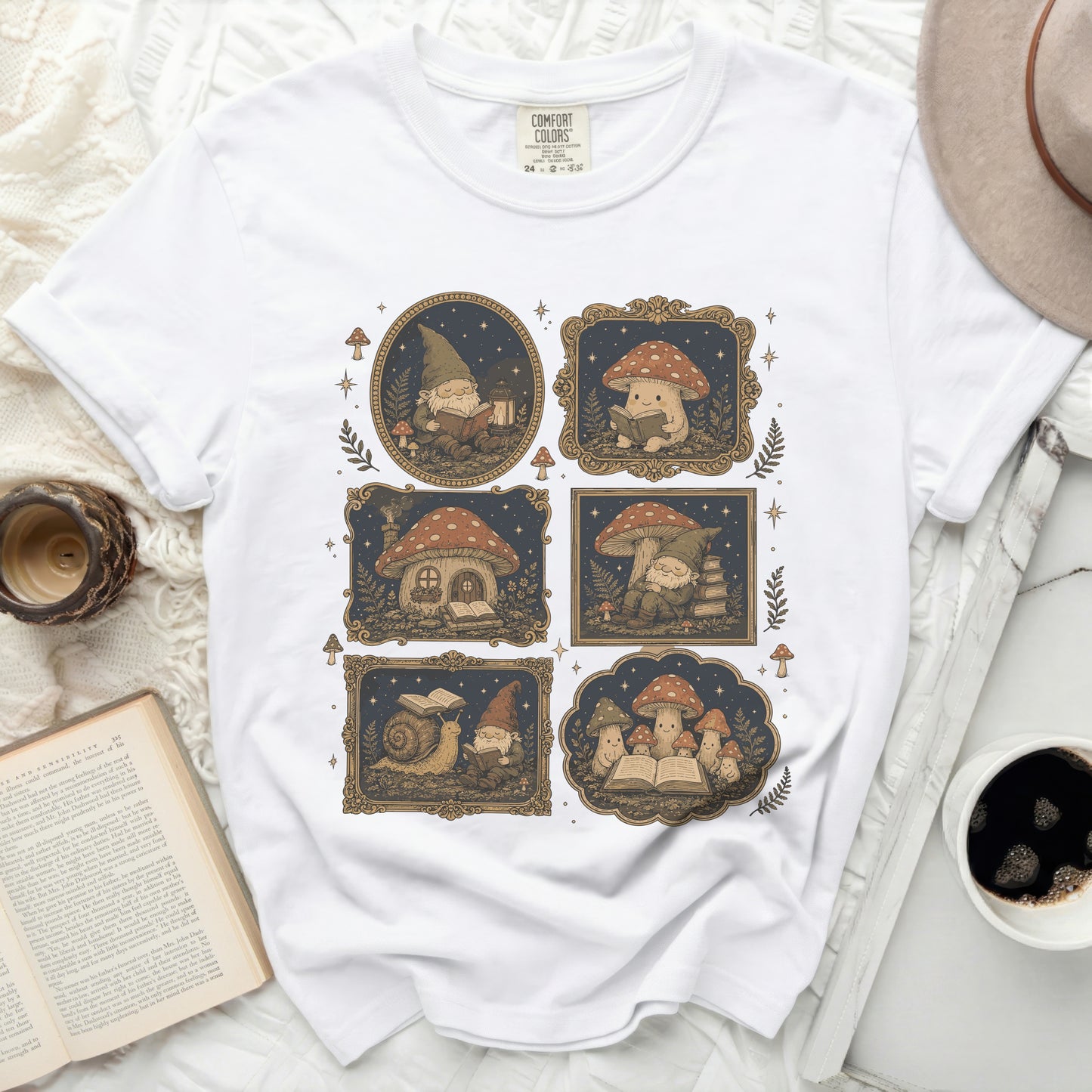 White crewneck t-shirt featuring a repeating graphic of gnomes, mushrooms, and snails reading books.