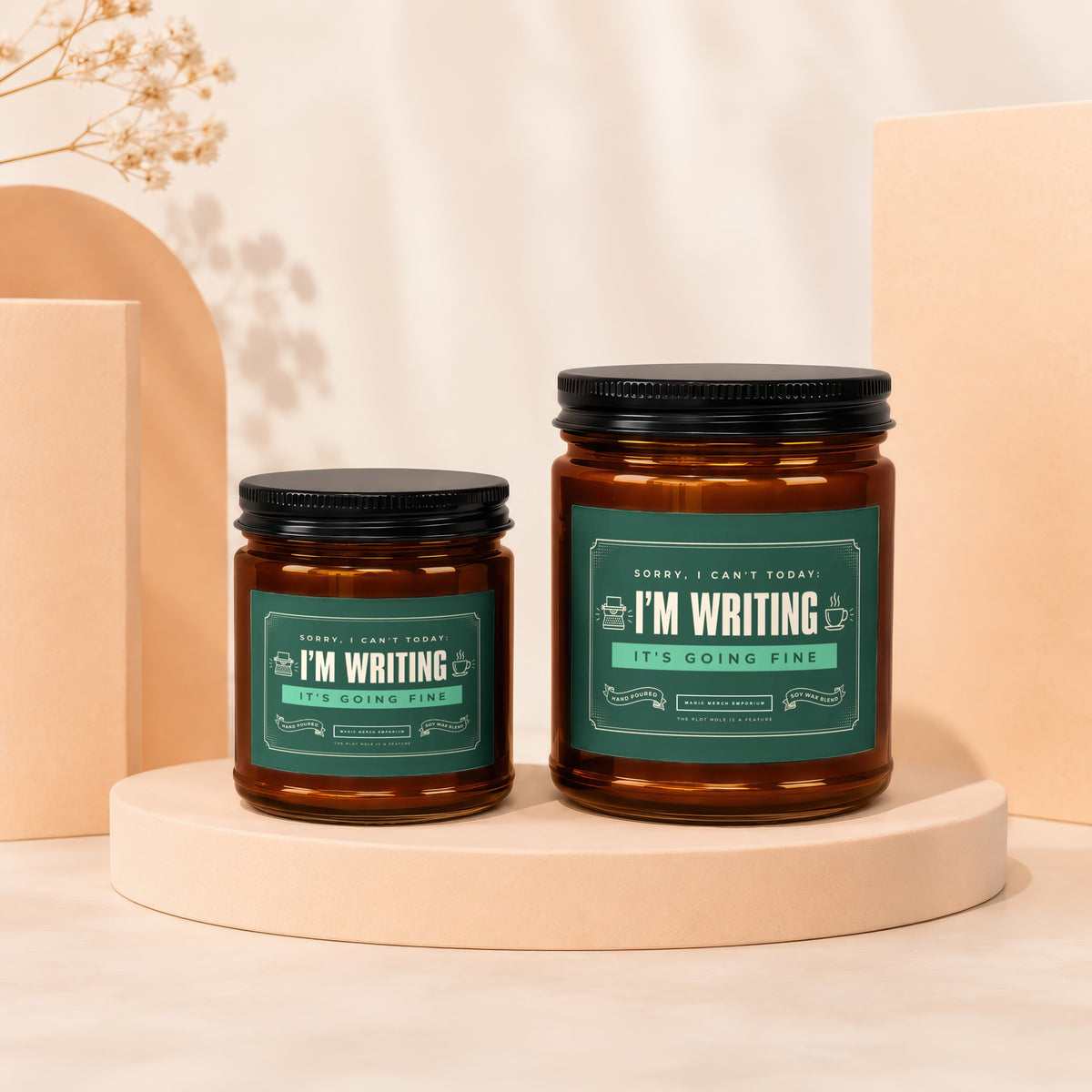 Two amber glass candles with green labels reading "I'M WRITING IT'S GOING FINE".