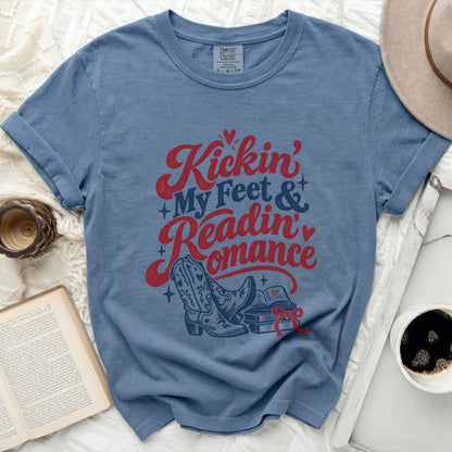 Blue t-shirt with "Kickin' My Feet & Readin' Romance" text and cowboy boots.