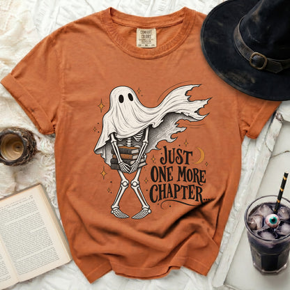 Skeleton ghost with books under a cape, reading "Just One More Chapter".