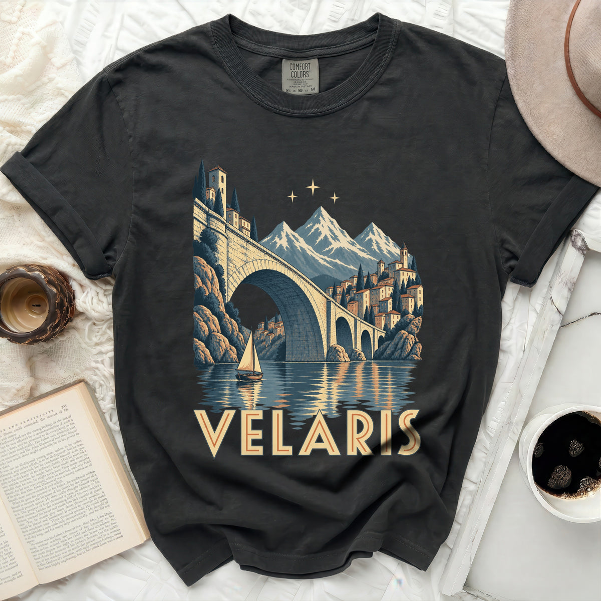 Dark t-shirt with "VELARIS" graphic featuring a bridge, mountains, and sailboat.