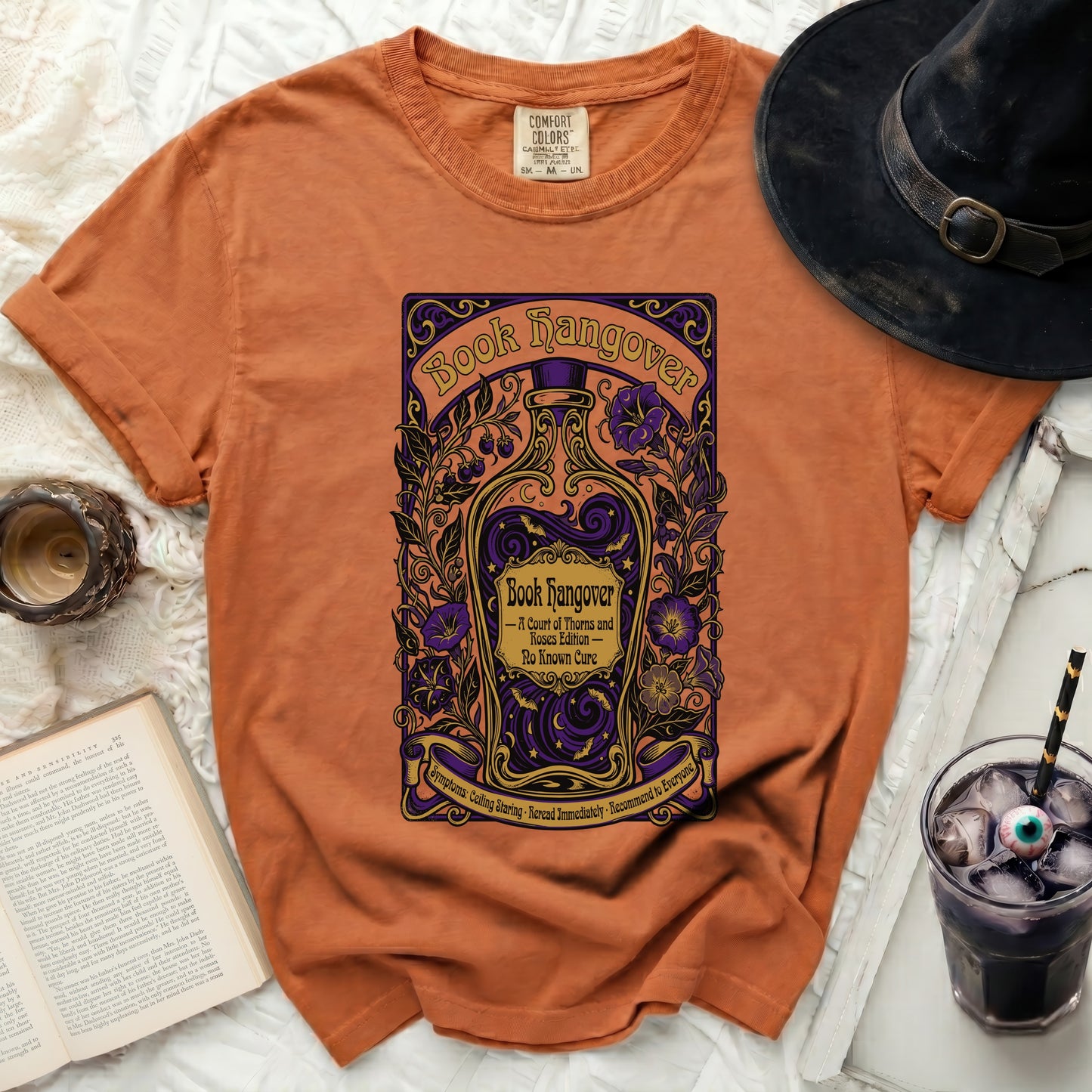 Orange t-shirt with "Book Hangover" design featuring a bottle and flowers.