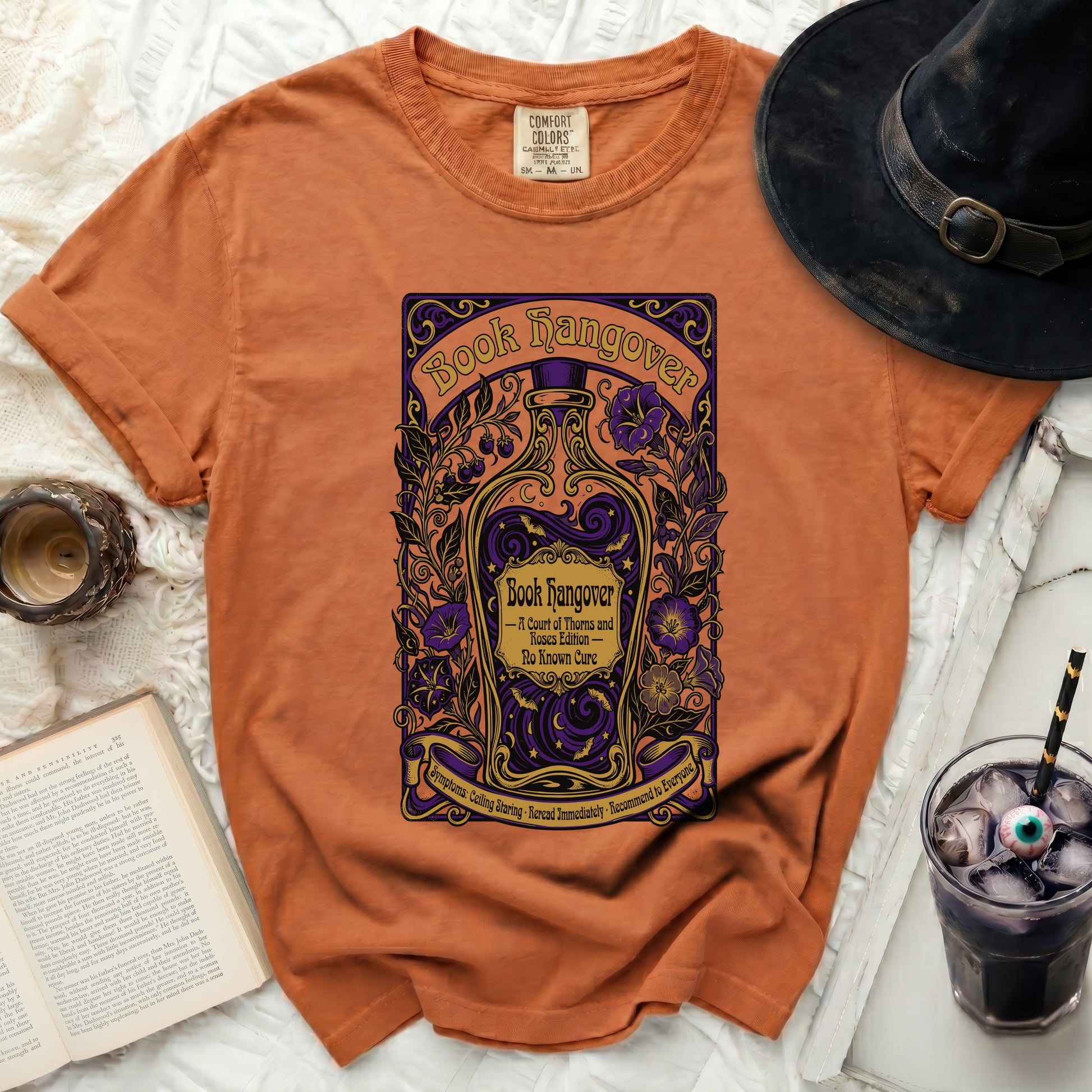Orange t-shirt with "Book Hangover" design featuring a bottle and flowers.
