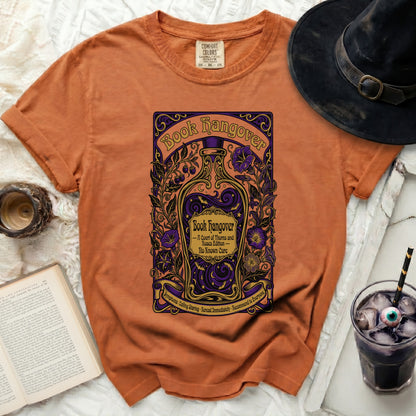 Orange t-shirt with "Book Hangover" design featuring a bottle and flowers.