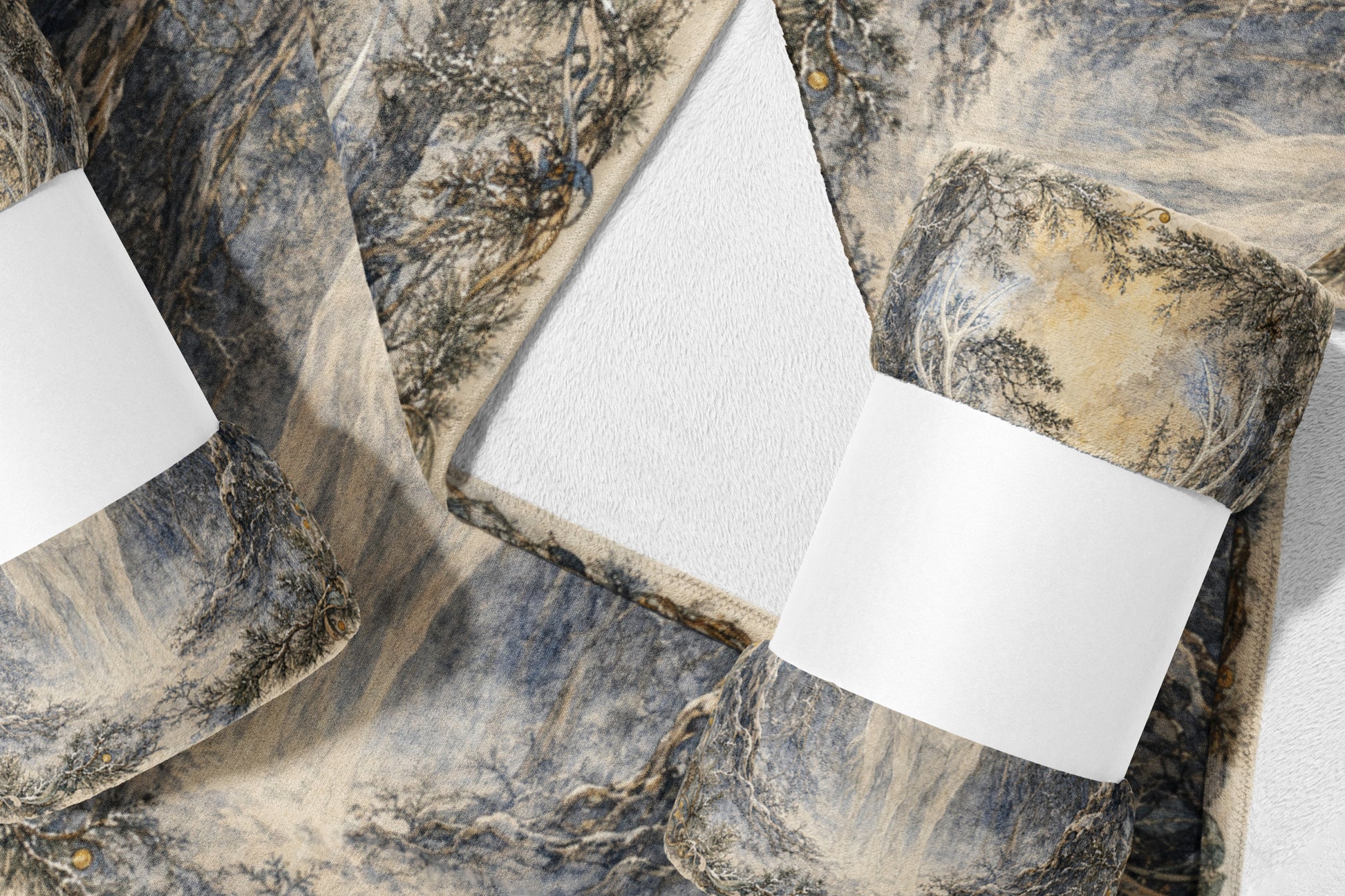Two rolled blankets feature a winter forest tree design with white labels.