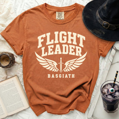 Orange t-shirt with "FLIGHT LEADER BASGIATH" text and wings design.