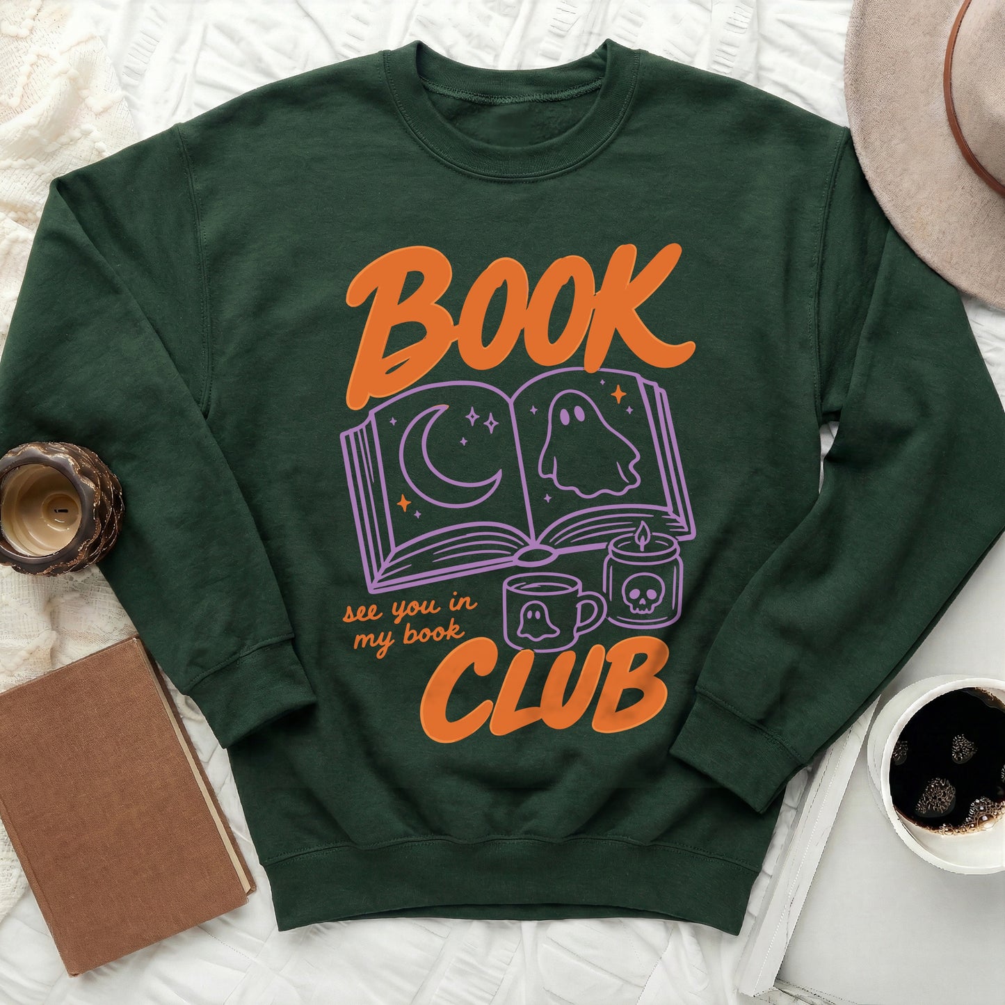 Green sweatshirt with orange text "BOOK CLUB" and spooky book graphics.