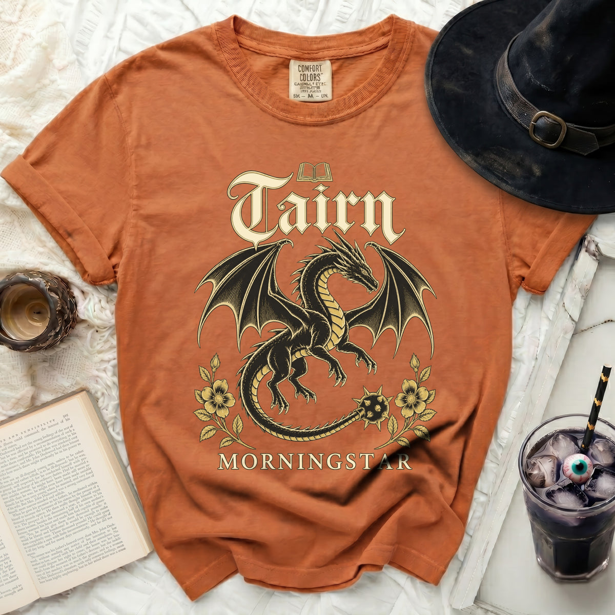 Orange t-shirt with a black dragon and flowers graphic, "Tairn Morningstar" text.