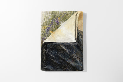 Towel with floral print and dark, textured pattern on white background