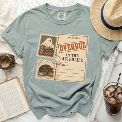T-shirt with "Overdue in the Afterlife" library card graphic.