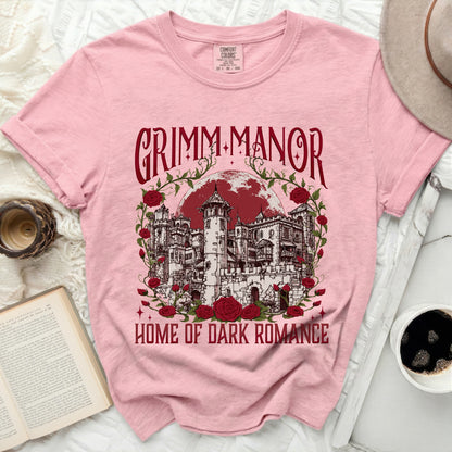 Pink t-shirt with "GRIMM MANOR HOME OF DARK ROMANCE" and castle graphic.