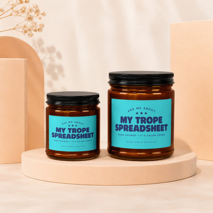 Two amber glass candles with blue labels reading "My Trope Spreadsheet."