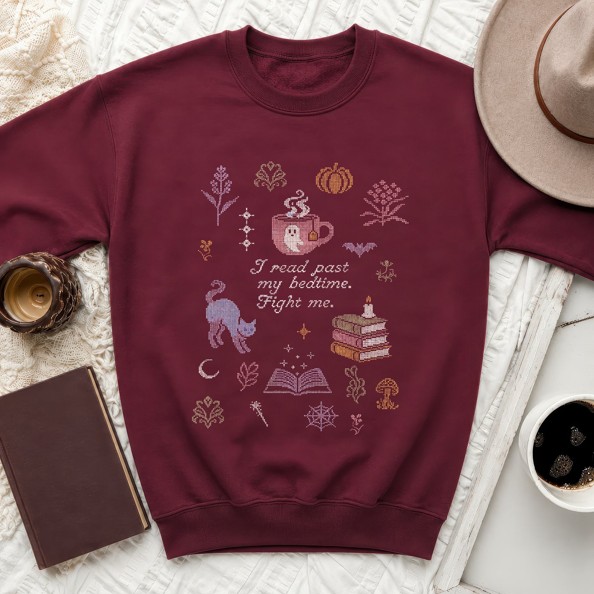 Maroon sweatshirt with ghost in teacup, cat, books, and text: "I read past my bedtime. Fight me."