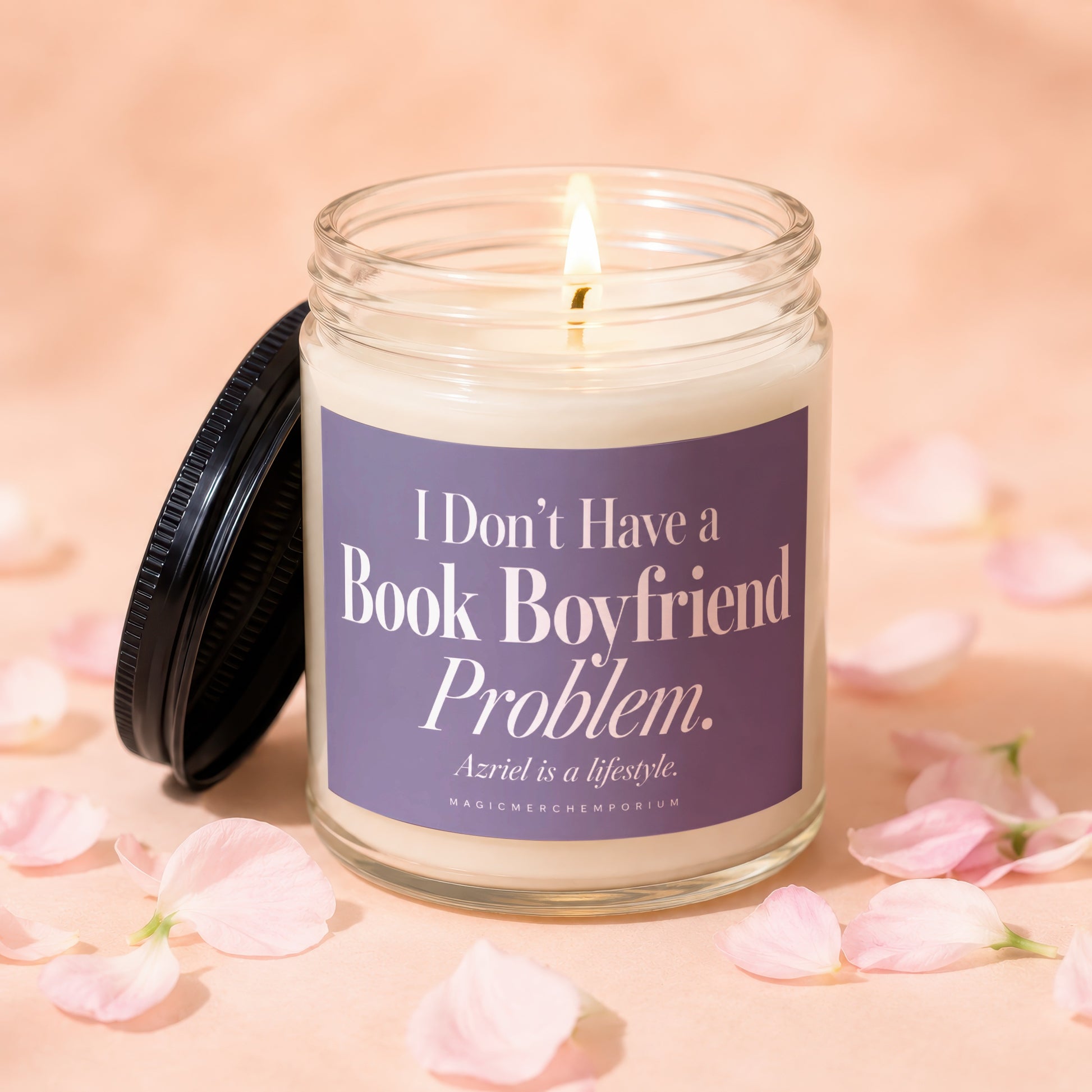 A lit candle in a glass jar with a purple label featuring white text.