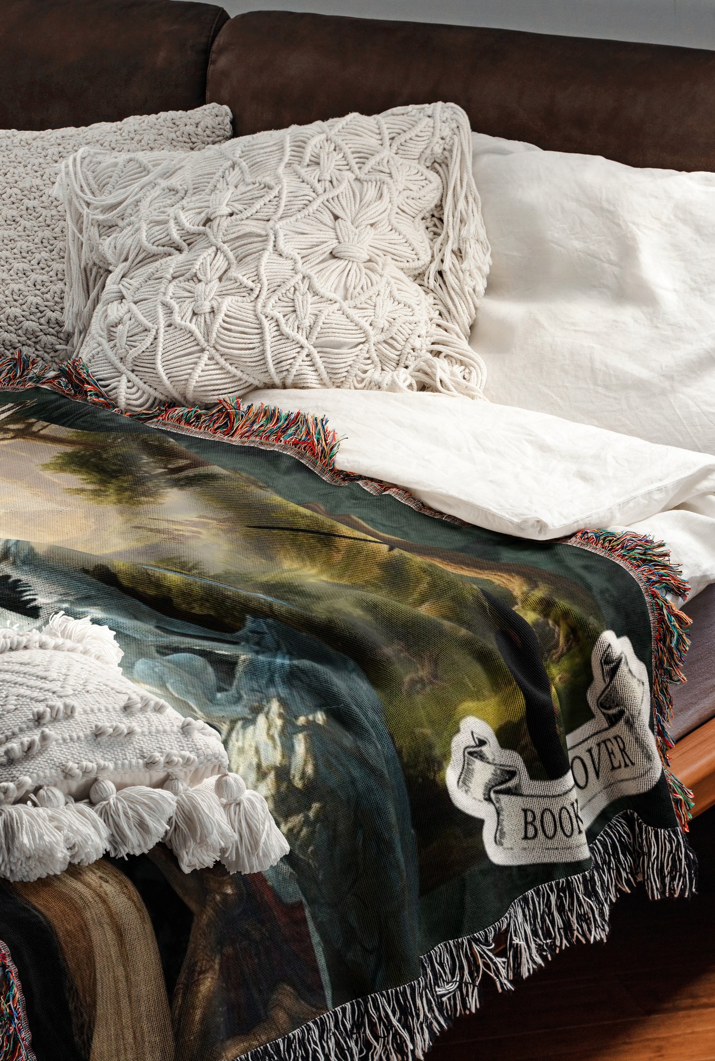 a cozy bedroom scene with a bed covered in a colorful throw blanket featuring a floral pattern. The bed is adorned with white pillows and a white comforter, creating a warm and inviting atmosphere.