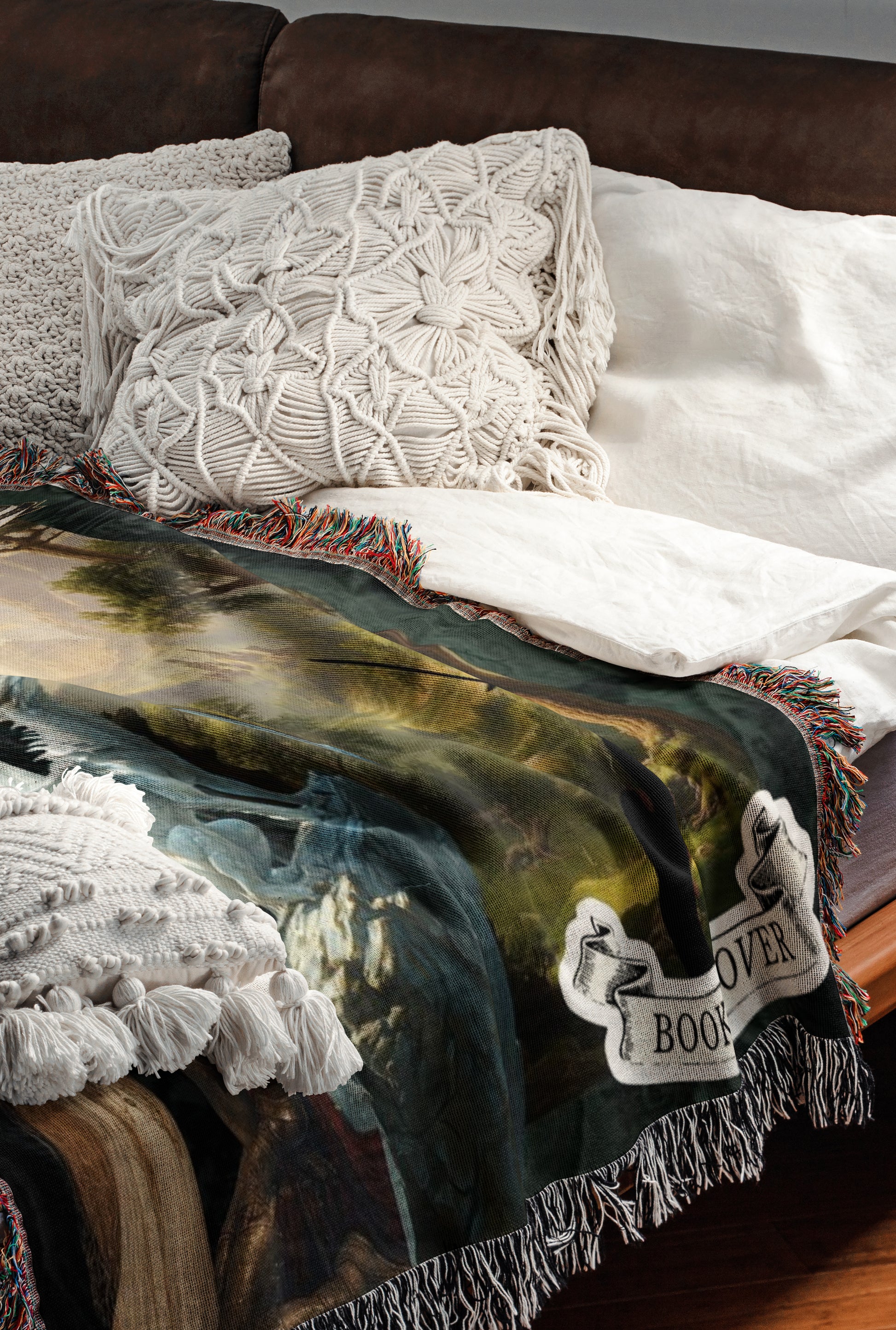 a cozy bedroom scene with a bed covered in a colorful throw blanket featuring a floral pattern. The bed is adorned with white pillows and a white comforter, creating a warm and inviting atmosphere.