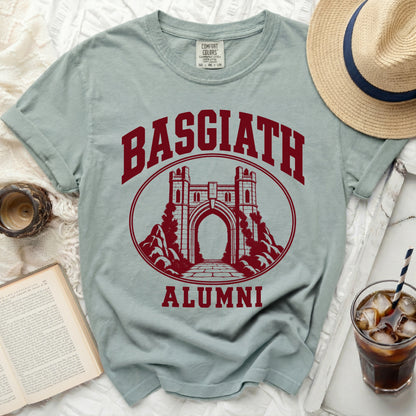 Sage green t-shirt featuring a maroon graphic of a stone archway with the text Basgiath Alumni.