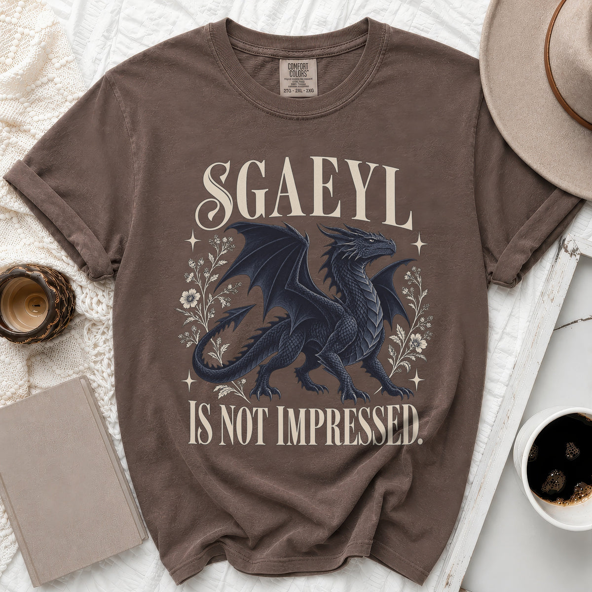 Brown t-shirt with black dragon design and text "SGAEYL IS NOT IMPRESSED."