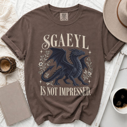 Brown t-shirt with black dragon design and text "SGAEYL IS NOT IMPRESSED."