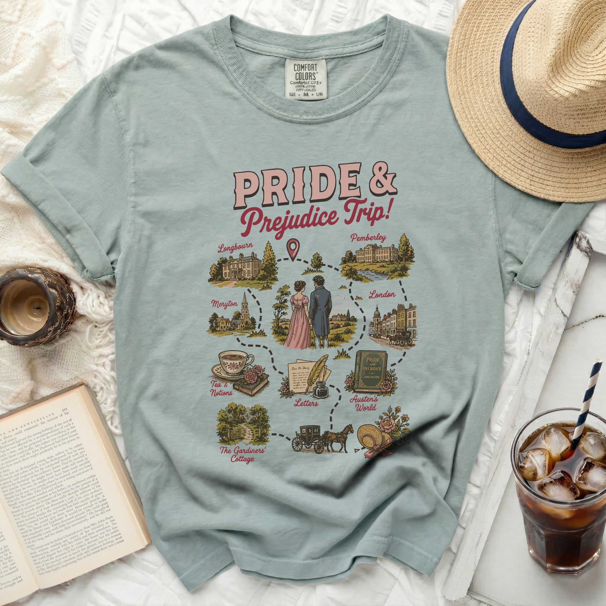 Dusty blue t-shirt with "Pride & Prejudice Trip!" map graphic of locations and scenes.