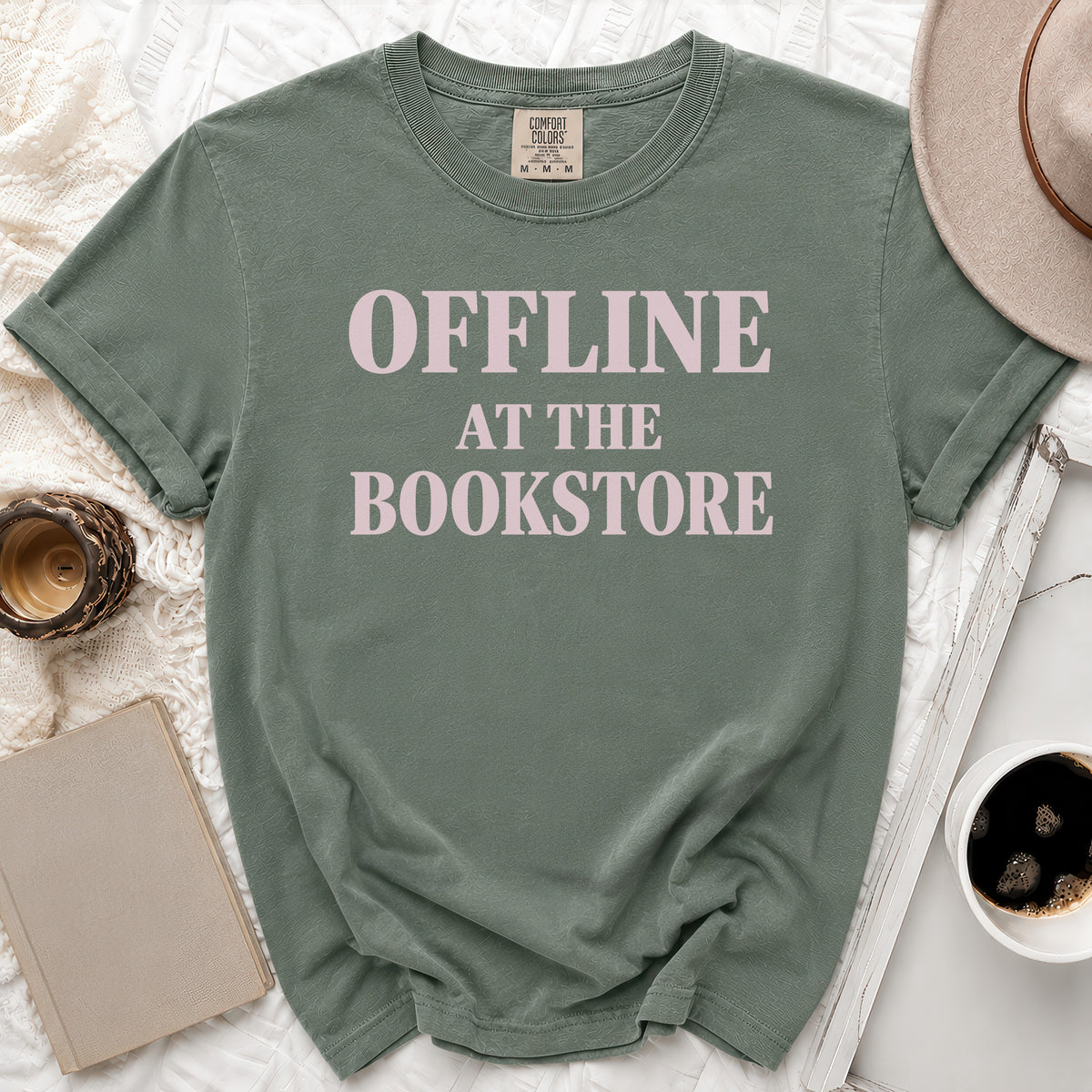 Green t-shirt with pink text reading "OFFLINE AT THE BOOKSTORE".