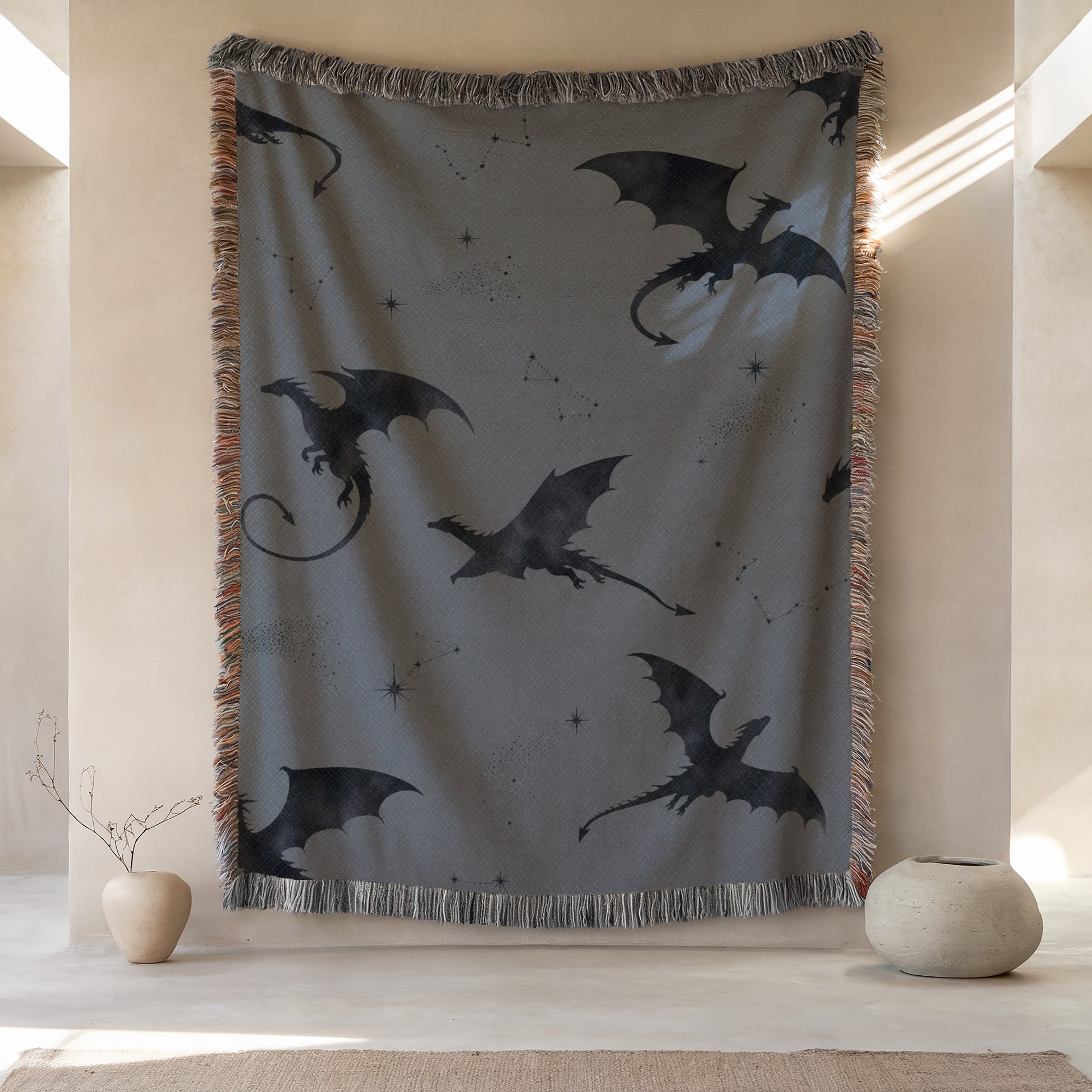 a large tapestry hanging on a wall, depicting a dragon design with stars and a starburst pattern. The tapestry is framed by a fringe border and is placed next to two small vases.