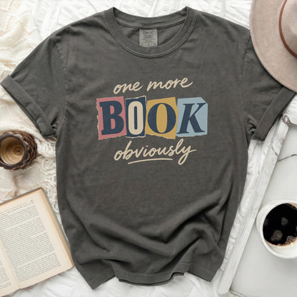 Comfort Colors t-shirt with "one more BOOK obviously" graphic in pastel colors.