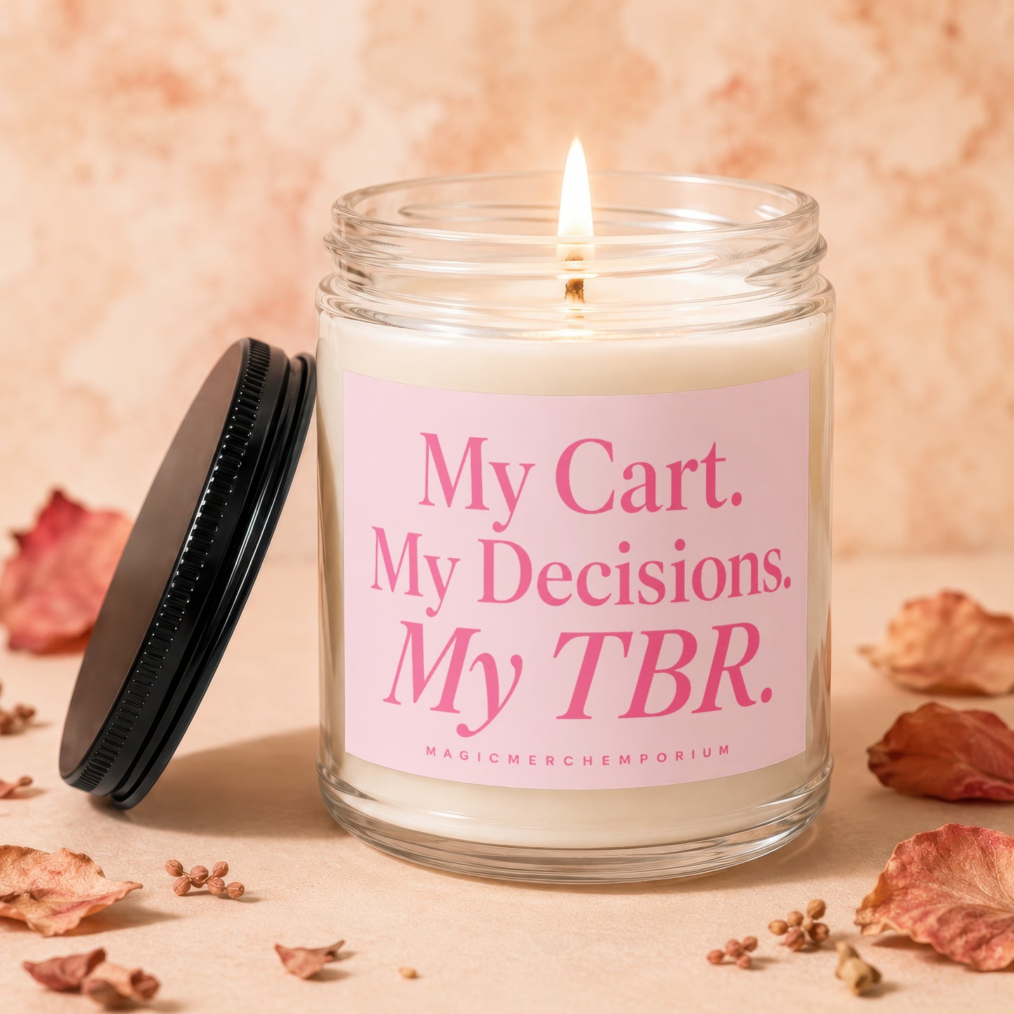 Lit candle in glass jar with pink label reading "My Cart. My Decisions. My TBR. MAGICMERCH."