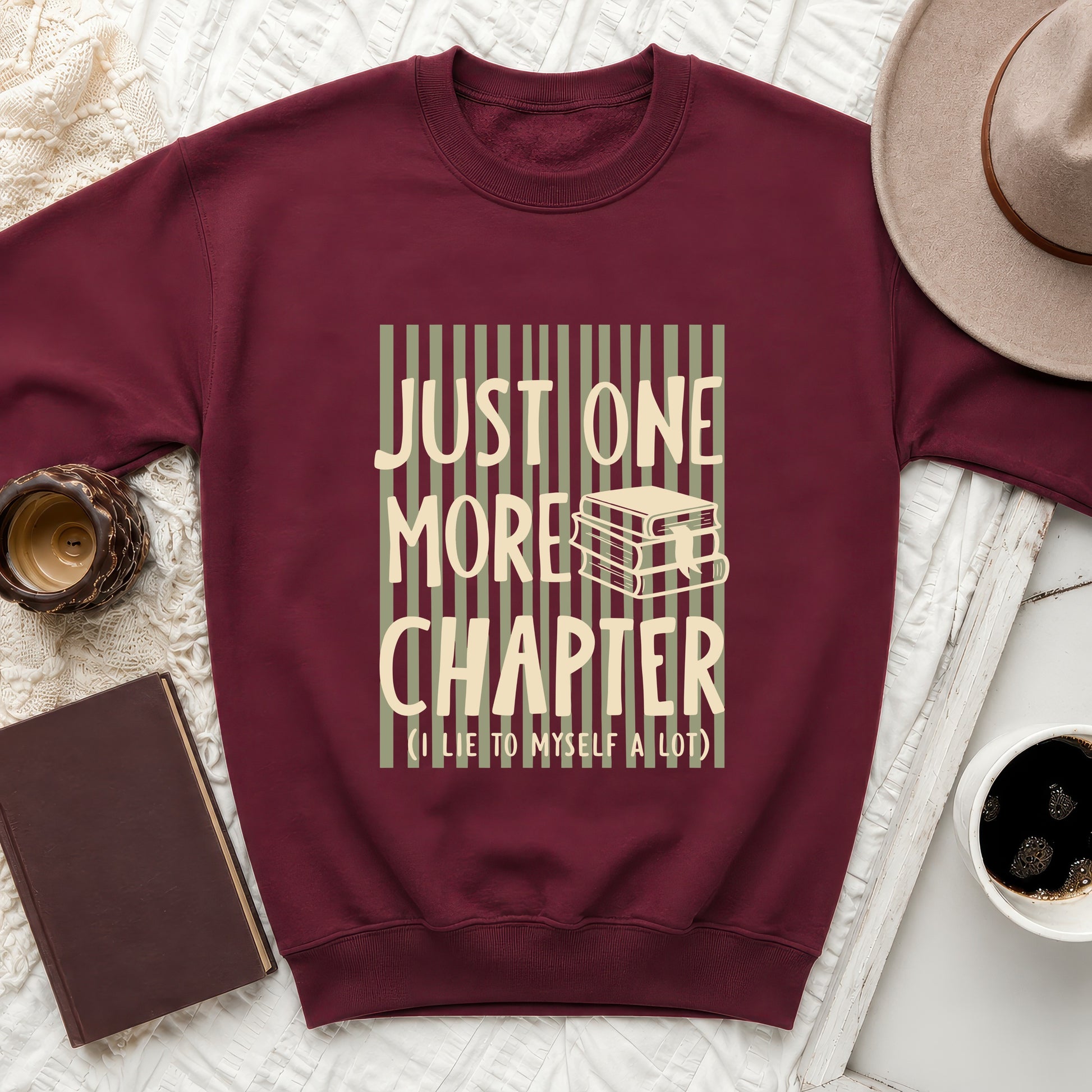 Maroon sweatshirt with "JUST ONE MORE CHAPTER (I LIE TO MYSELF A LOT)" text.