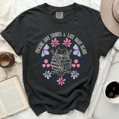Dark t-shirt with "Pucking love stories & late night reads" text and floral hockey design.