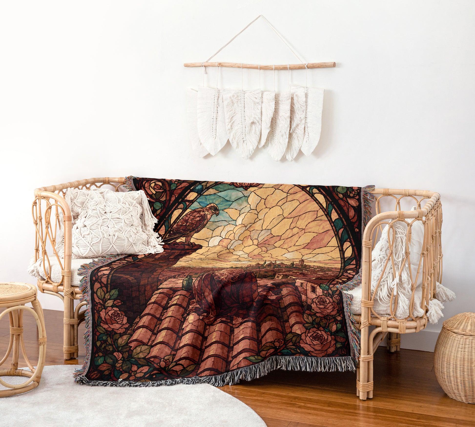 a cozy living room with a woven bench, a colorful woven blanket, and a wall hanging with white feathers.