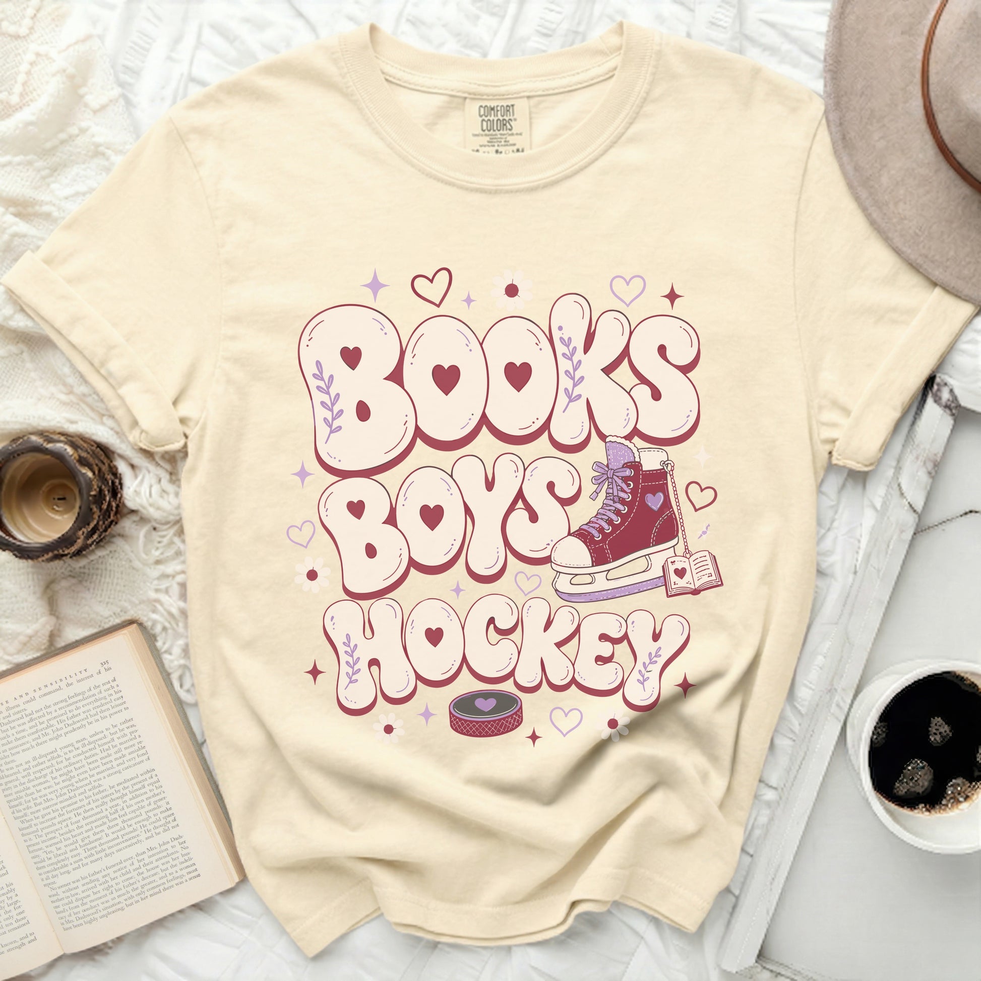 Cream t-shirt with "Books Boys Hockey" text and heart-decorated roller skate.