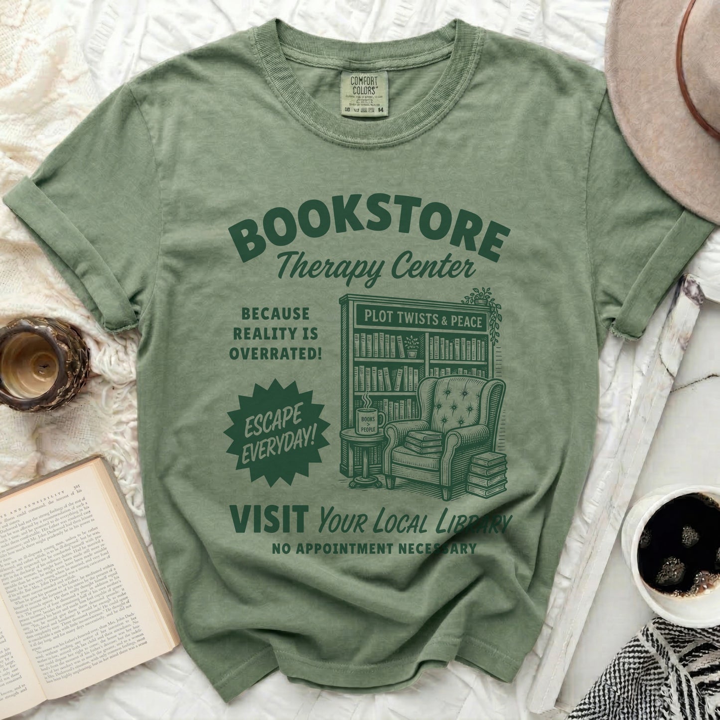 Green t-shirt with "Bookstore Therapy Center" graphic and armchair illustration.