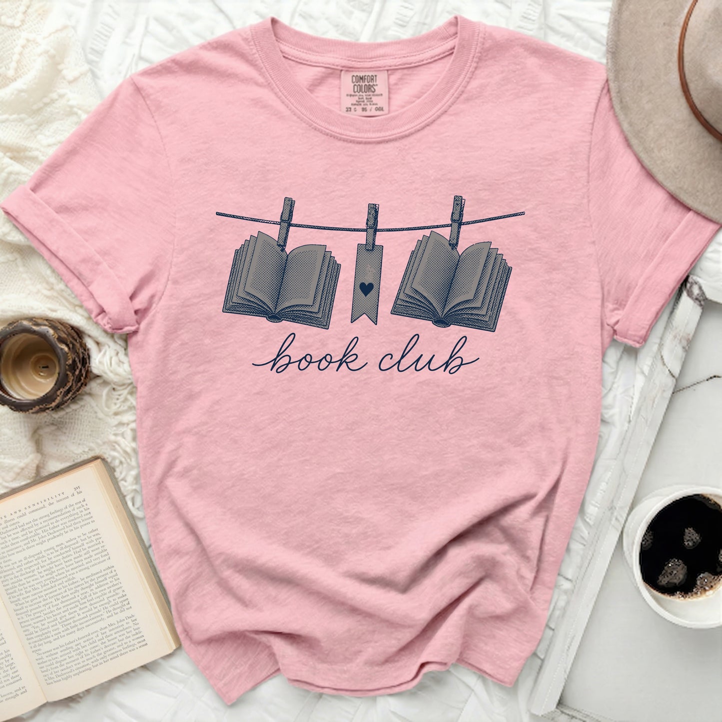Pink t-shirt with "book club" and hanging books graphic.