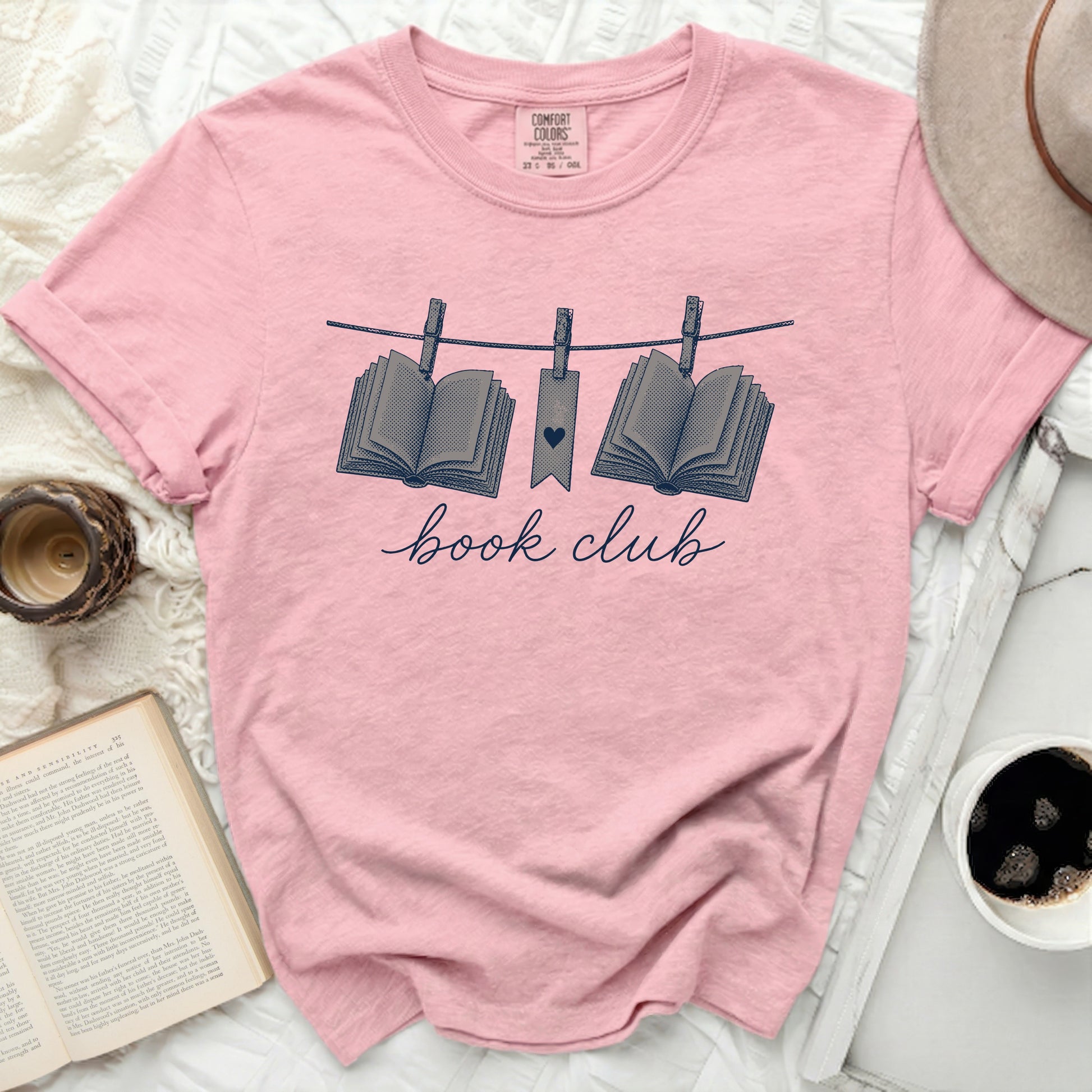 Pink t-shirt with "book club" and hanging books graphic.