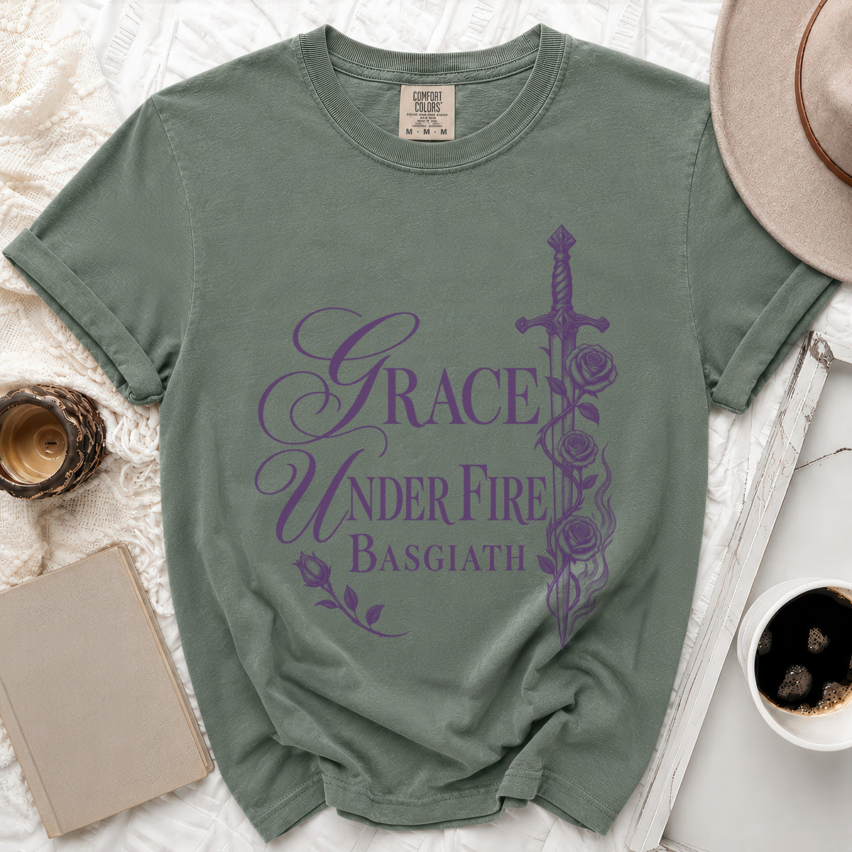 Sage green t-shirt with purple text "Grace Under Fire Basgiath" and sword illustration.