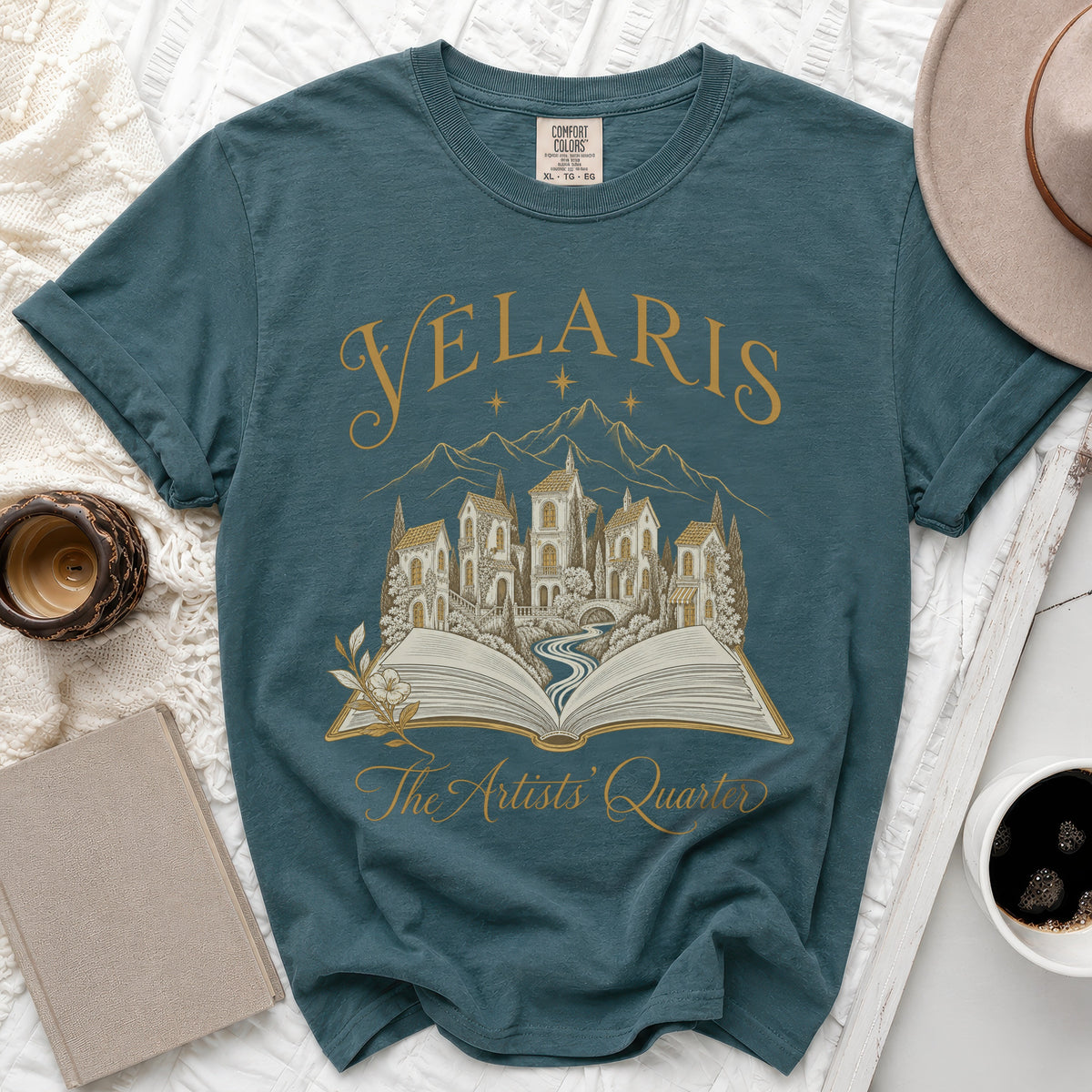 Teal t-shirt with "Velaris The Artists' Quarter" text and illustration.